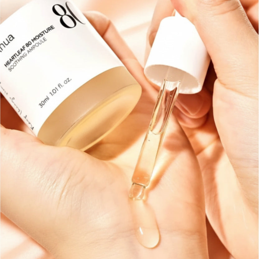 Hand holding a dropper with skincare product and bottle, showing redness reduction text.