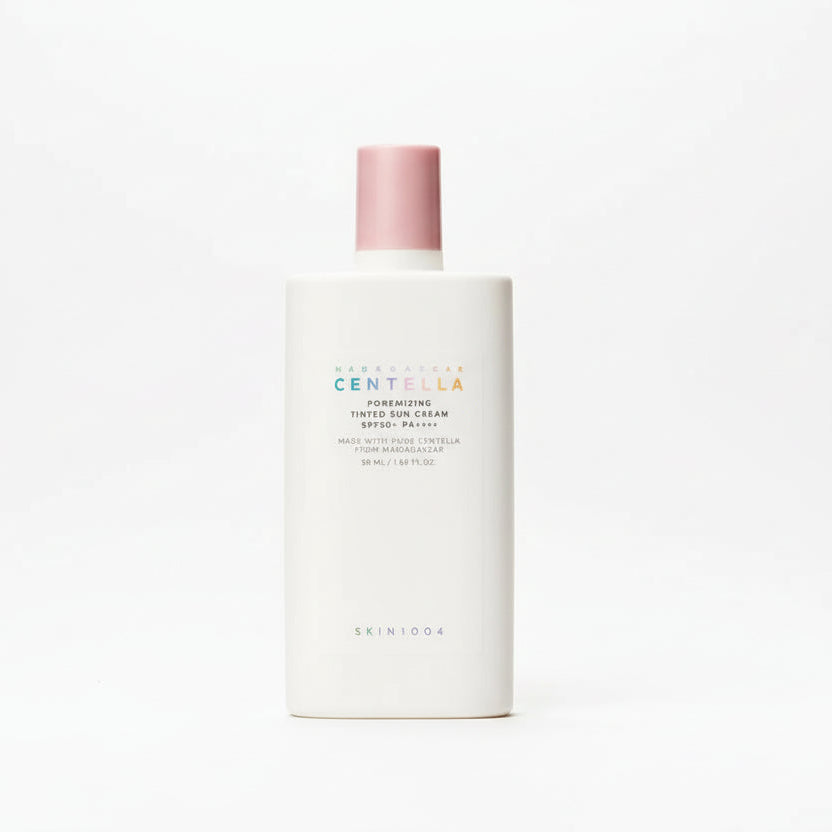 Skincare bottle with pink cap on a beige background