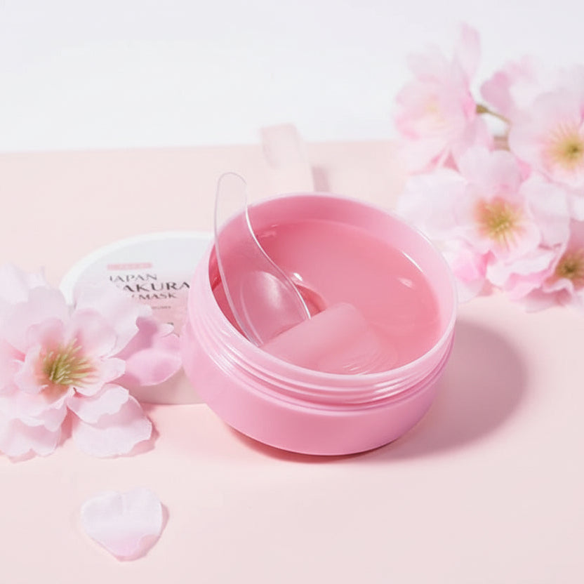 Pink eye mask container with cherry blossom flowers on a pink background