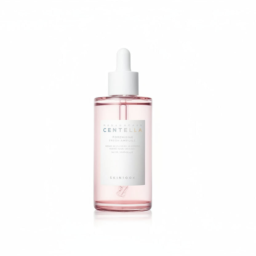 Skincare serum bottle with a white cap on a white background